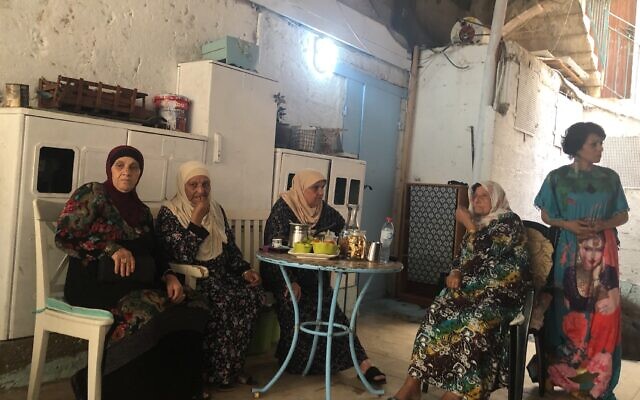 Tina (far right), an Arab resident of Acre, with some of her neighbors. She tried to protect the Jewish-owned gallery where she worked during the recent unrest in the mixed city, and is asking how and why this happened in her city (Jessica Steinberg/Times of Israel)