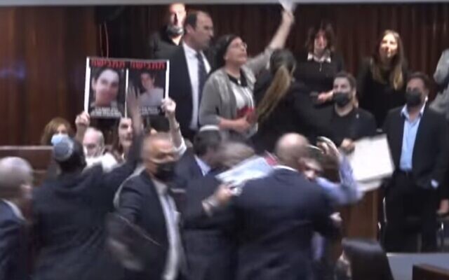 Screen capture from video of MKs holding up potraits of terror victims during a a protest against the confirmation of the new government, June 13, 2021. (YouTube) Screen capture from video of MKs holding up potraits of terror victims during a a protest against the confirmation of the new government, June 13, 2021. (YouTube)