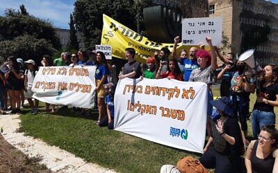Environmental activists mark World Oceans Day on June 8, 2021, by protesting at the Knesset against an agreement to allow the transfer of Gulf oil to Europe using Israel as a landbridge. (Twitter)