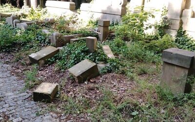 Toppled and smashed headstones lie scattered at the Jewish Cemetery of Wroclaw, Poland, June 16, 2021. (The Jewish Community of Wroclaw via JTA)