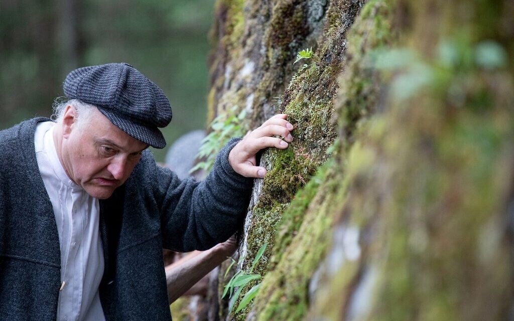 Director, actor and author of the theatre group Teatro Caprile, Andreas Kosek reenacts an emigration scene on the old Roman road in the Krimmler Tauern Alps on the border between Austria and Italy, near Krimml, on June 25, 2021. (ALEX HALADA/AFP)