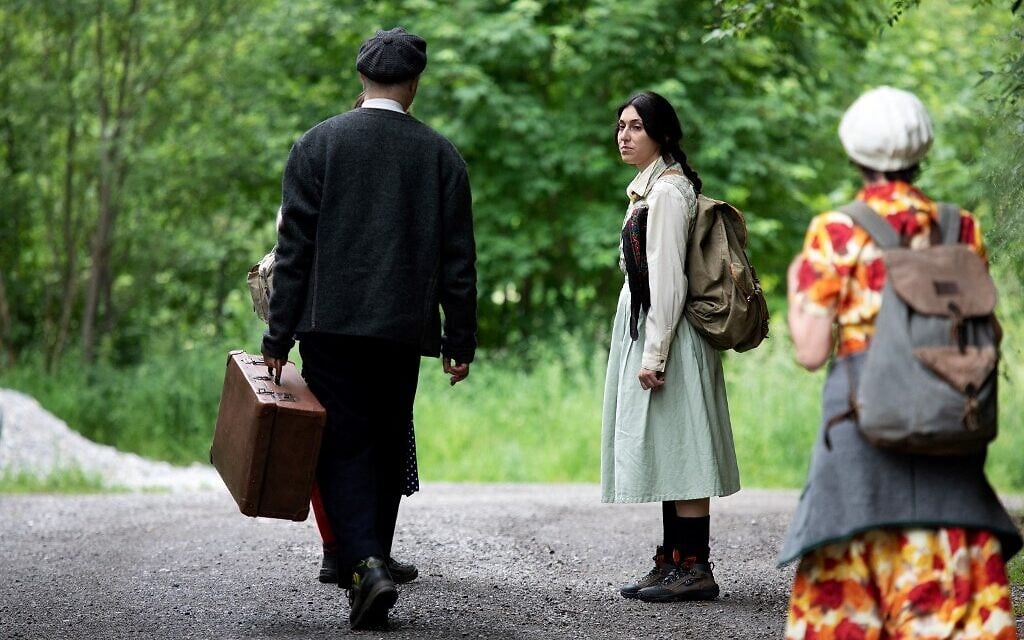 Actors of the theatre group Teatro Caprile reenact an emigration scene on an old Roman road in the Krimmler Tauern Alps on the border between Austria and Italy in Krimml, on June 25, 2021. (ALEX HALADA/AFP)