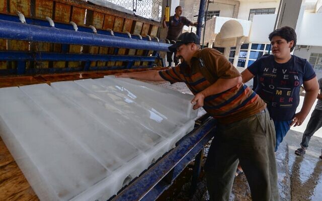 An Iraqi man buys ice blocks at a factory in the northern city of Mosul, on July 3, 2021, amid power outages and soaring temperatures. (Zaid Al-Obeidi/AFP) An Iraqi man buys ice blocks at a factory in the northern city of Mosul, on July 3, 2021, amid power outages and soaring temperatures. (Zaid Al-Obeidi/AFP)