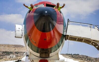Palestinian twin brothers Atallah and Khamis al-Sairafi, 60, pose from the cockpit of a Boeing 707 aircraft being converted into a restaurant near the city of Nablus in the West Bank on July 5, 2021. (Photo by JAAFAR ASHTIYEH / AFP)