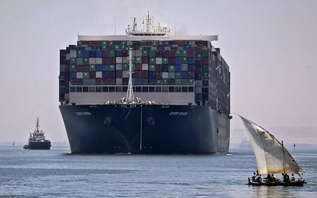 The Panama-flagged MV 'Ever Given' container ship sails near a felucca along Egypt's Suez Canal near the canal's central city of Ismailia, July 7, 2021. (Mahmoud KHALED / AFP)