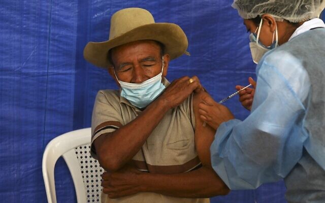 A man receives a dose of the AstraZeneca coronavirus vaccine donated by the US, at a vaccination center in San Juan Sacatepequez, Guatemala, on July 15, 2021. (Johan Ordonez/AFP) A man receives a dose of the AstraZeneca coronavirus vaccine donated by the US, at a vaccination center in San Juan Sacatepequez, Guatemala, on July 15, 2021. (Johan Ordonez/AFP)