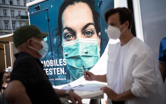 People register to get vaccinated at a mobile pop-up vaccination station at Hermannplatz square in Berlin's Neukoelln district on July 16, 2021, amid the coronavirus pandemic. (STEFANIE LOOS / AFP)