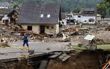 A man walk on a road amid destroyed houses after the floods caused major damage in Schuld near Bad Neuenahr-Ahrweiler, western Germany, on July 16, 2021 (CHRISTOF STACHE / AFP)