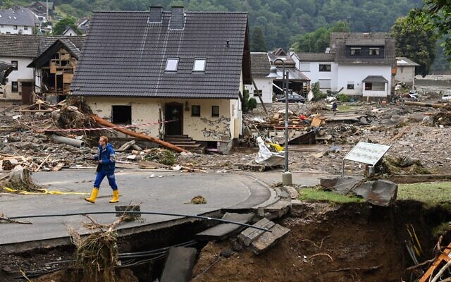 A man walk on a road amid destroyed houses after the floods caused major damage in Schuld near Bad Neuenahr-Ahrweiler, western Germany, on July 16, 2021 (CHRISTOF STACHE / AFP) A man walk on a road amid destroyed houses after the floods caused major damage in Schuld near Bad Neuenahr-Ahrweiler, western Germany, on July 16, 2021 (CHRISTOF STACHE / AFP)