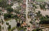 This aerial view taken in Brommelen, Netherlands, shows the flooded area around the Meuse after a levee of the Juliana Canal broke, July 16, 2021. (Remko de Waal/ANP/AFP)