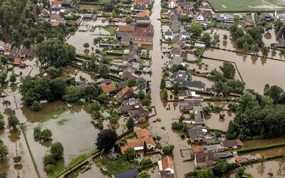 This aerial view taken in Brommelen, Netherlands, shows the flooded area around the Meuse after a levee of the Juliana Canal broke, July 16, 2021. (Remko de Waal/ANP/AFP)