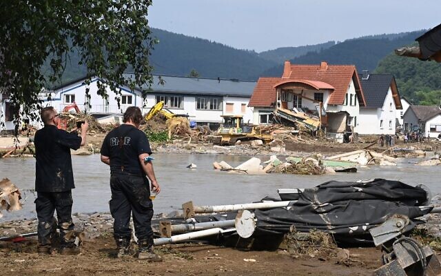 A worker (L) takes a picture of a destroyed area in Insul near Bad Neuenahr-Ahrweiler, western Germany, on July 17, 2021. (Photo by CHRISTOF STACHE / AFP) A worker (L) takes a picture of a destroyed area in Insul near Bad Neuenahr-Ahrweiler, western Germany, on July 17, 2021. (Photo by CHRISTOF STACHE / AFP)