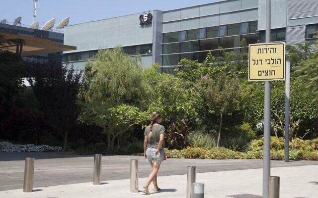 In this file photo taken on August 28, 2016, a woman walks outside the building housing the Israeli NSO group, in Herzliya. (Jack Guez/AFP) In this file photo taken on August 28, 2016, a woman walks outside the building housing the Israeli NSO group, in Herzliya. (Jack Guez/AFP)