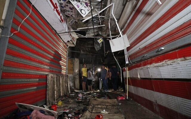 Iraqis inspect the site of the explosion in a popular market in the mostly Shiite neighbourhood of Sadr City, east of Baghdad, on July 19, 2021. (Ahmad Al-Rubaye/AFP) Iraqis inspect the site of the explosion in a popular market in the mostly Shiite neighbourhood of Sadr City, east of Baghdad, on July 19, 2021. (Ahmad Al-Rubaye/AFP)