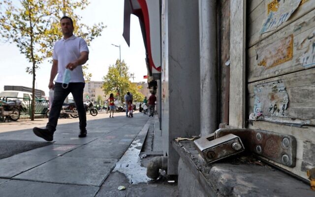 An Iranian man walks past a shuttered store in the capital Tehran, on July 20, 2021. (ATTA KENARE / AFP) An Iranian man walks past a shuttered store in the capital Tehran, on July 20, 2021. (ATTA KENARE / AFP)