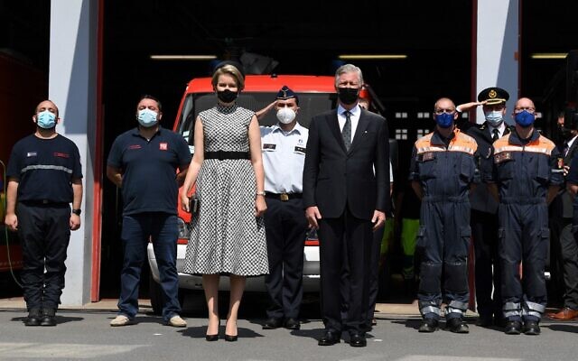 King Philippe of Belgium (C right) and Queen Mathilde of Belgium (C left) respect a minute of silence during a tribute ceremony, part of the national mourning day for victims of the severe floods, in Verviers, on July 20, 2021. (JOHN THYS / AFP)