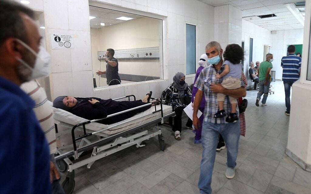 A patient rests on a bed in a hallway of the Rafic Hariri University Hospital in Lebanon's capital Beirut, on July 23, 2021. (STR/AFP) A patient rests on a bed in a hallway of the Rafic Hariri University Hospital in Lebanon's capital Beirut, on July 23, 2021. (STR/AFP)