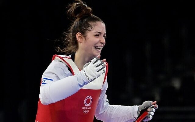 Israel's Abishag Semberg celebrates winning the taekwondo women's -49kg bronze medal A bout during the Tokyo 2020 Olympic Games at the Makuhari Messe Hall in Tokyo, on July 24, 2021. (Javier Soriano/AFP)
