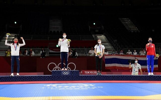 From left to right: Spain's Adriana Cerezo Iglesias (silver), Thailand's Panipak Wongpattanakit (gold) and Israel's Avishag Semberg (bronze) and Serbia's Tijana Bogdanovic (bronze) pose on the podium after the taekwondo women's -49kg bouts during the Tokyo 2020 Olympic Games at the Makuhari Messe Hall in Tokyo, on July 24, 2021. (Javier Soriano/AFP) From left to right: Spain's Adriana Cerezo Iglesias (silver), Thailand's Panipak Wongpattanakit (gold) and Israel's Avishag Semberg (bronze) and Serbia's Tijana Bogdanovic (bronze) pose on the podium after the taekwondo women's -49kg bouts during the Tokyo 2020 Olympic Games at the Makuhari Messe Hall in Tokyo, on July 24, 2021. (Javier Soriano/AFP)