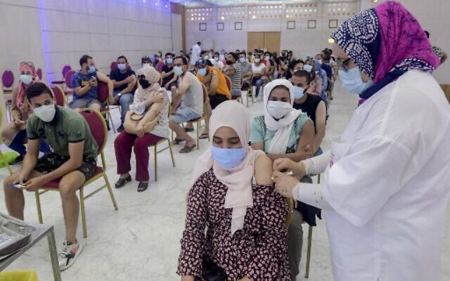 In this file photo taken on July 20, 2021, a Tunisian woman receives a dose of the Chinese Sinopharm vaccine at the Palais des Congres in the capital Tunis.(Fethi Belaid/AFP) In this file photo taken on July 20, 2021, a Tunisian woman receives a dose of the Chinese Sinopharm vaccine at the Palais des Congres in the capital Tunis.(Fethi Belaid/AFP)