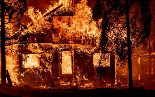 A home burns as flames from the Dixie fire tear through the Indian Falls neighborhood of unincorporated Plumas County, California on July 24, 2021. (JOSH EDELSON / AFP)