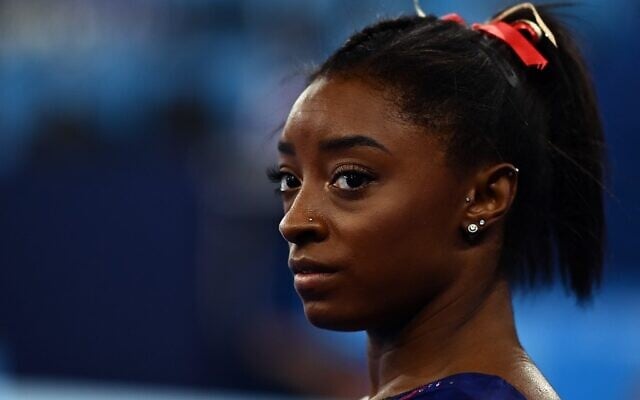 USA's Simone Biles gets ready to compete in the uneven bars event of the  artistic gymnastics women's qualification during the Tokyo 2020 Olympic Games at the Ariake Gymnastics Centre in Tokyo on July 25, 2021. (Loic VENANCE / AFP)