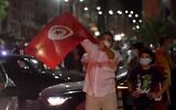 People celebrate in the street after Tunisian President Kais Saied announced the dissolution of parliament and Prime Minister Hichem Mechichi's government in Tunis on July 25, 2021, after a day of nationwide protest. (FETHI BELAID / AFP)
