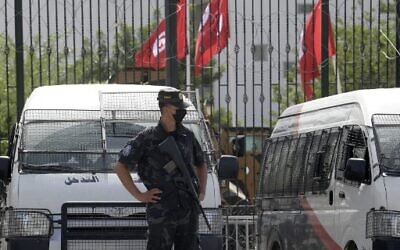 Tunisian police stand guard outside the parliament in Tunis on July 27, 2021. (Photo by FETHI BELAID / AFP)