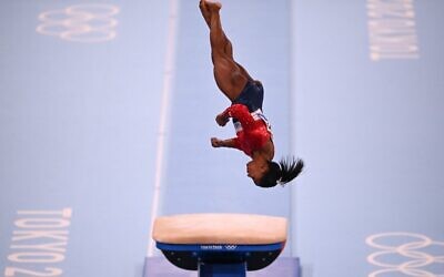 US's Simone Biles competes in the vault event of the artistic gymnastics women's team final during the Tokyo 2020 Olympic Games at the Ariake Gymnastics Centre in Tokyo on July 27, 2021. (Martin BUREAU / AFP)