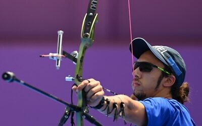 Israeli archer Itay Shanny competes in the men's individual eliminations during the Tokyo 2020 Olympic Games at Yumenoshima Park Archery Field in Tokyo on July 28, 2021. (Photo by ADEK BERRY / AFP)