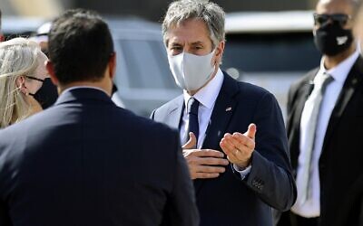 US Secretary of State Antony Blinken (C) speaks with officials before he boards his plane on his return to the United States from Kuwait International Airport in Kuwait City, on July 29, 2021. (Jonathan Ernst/Pool/ AFP)