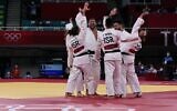 Team Israel celebrates winning the judo mixed team's repechage bout against Brazil during the Tokyo 2020 Olympic Games at the Nippon Budokan in Tokyo on July 31, 2021. (Jack GUEZ / AFP)
