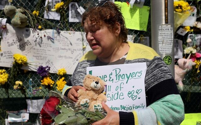Maria Perdomo becomes emotional as she visits the memorial that includes pictures of some of the victims of the collapsed 12-story Champlain Towers South condo building on July 08, 2021 in Surfside, Florida. (Joe Raedle/Getty Images/AFP) Maria Perdomo becomes emotional as she visits the memorial that includes pictures of some of the victims of the collapsed 12-story Champlain Towers South condo building on July 08, 2021 in Surfside, Florida. (Joe Raedle/Getty Images/AFP)