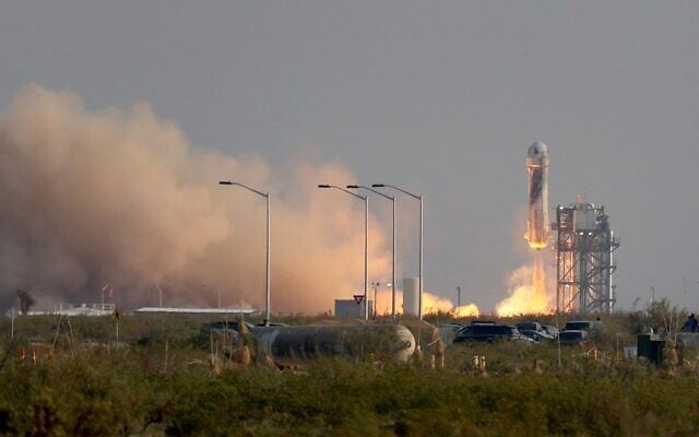 The New Shepard Blue Origin rocket lifts-off from the launch pad carrying Jeff Bezos along with his brother Mark Bezos, 18-year-old Oliver Daemen, and 82-year-old Wally Funk prepare to launch on July 20, 2021 in Van Horn, Texas. (Joe Raedle/Getty Images/AFP) The New Shepard Blue Origin rocket lifts-off from the launch pad carrying Jeff Bezos along with his brother Mark Bezos, 18-year-old Oliver Daemen, and 82-year-old Wally Funk prepare to launch on July 20, 2021 in Van Horn, Texas. (Joe Raedle/Getty Images/AFP)
