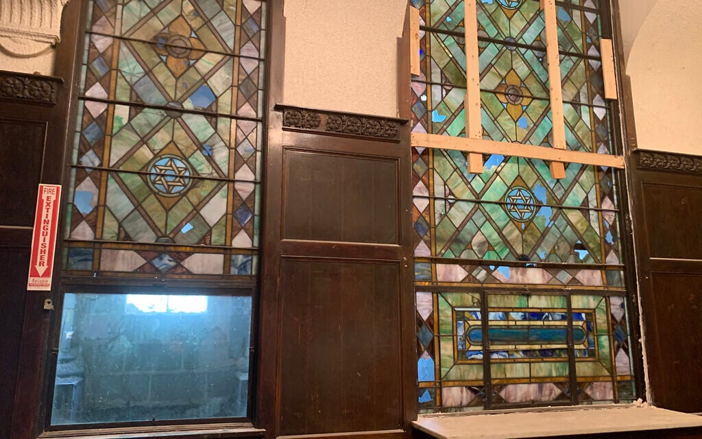 Stained-glass windows featuring Jewish iconography have survived decades longer than the congregation itself in Chicago's decrepit B'nei Bezalel building. Tom and Amber Ginsburg, who are renovating the structure, are inspired by the building's legacy as 'a holy place.' (Naomi Waxman/JTA)
