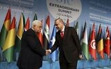 In this December 13, 2017 file photo, Turkey’s President Recep Tayyip Erdogan shakes hands with Palestinian Authority President Mahmoud Abbas at the Organization of Islamic Cooperation’s Extraordinary Summit in Istanbul. (Yasin Bulbul/Pool Photo via AP)
