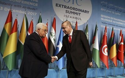 In this December 13, 2017 file photo, Turkey’s President Recep Tayyip Erdogan shakes hands with Palestinian Authority President Mahmoud Abbas at the Organization of Islamic Cooperation’s Extraordinary Summit in Istanbul. (Yasin Bulbul/Pool Photo via AP)