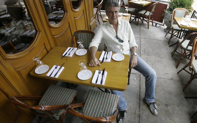 FILE- In this Aug. 8, 2007 file photo, Anthony Bourdain, host of theTravel Channel's "No Reservations," poses in a New York restaurant. Court papers show Bourdain was worth $1.2 million when he died in June 2018. Most of his estate was left to his 11-year-old daughter. (AP Photo/Mary Altaffer, File)