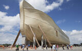 Visitors pass outside the front of a replica Noah's Ark at the Ark Encounter theme park during a media preview day, in Williamstown, Kentucky, July 5, 2016. (AP Photo/John Minchillo, File)