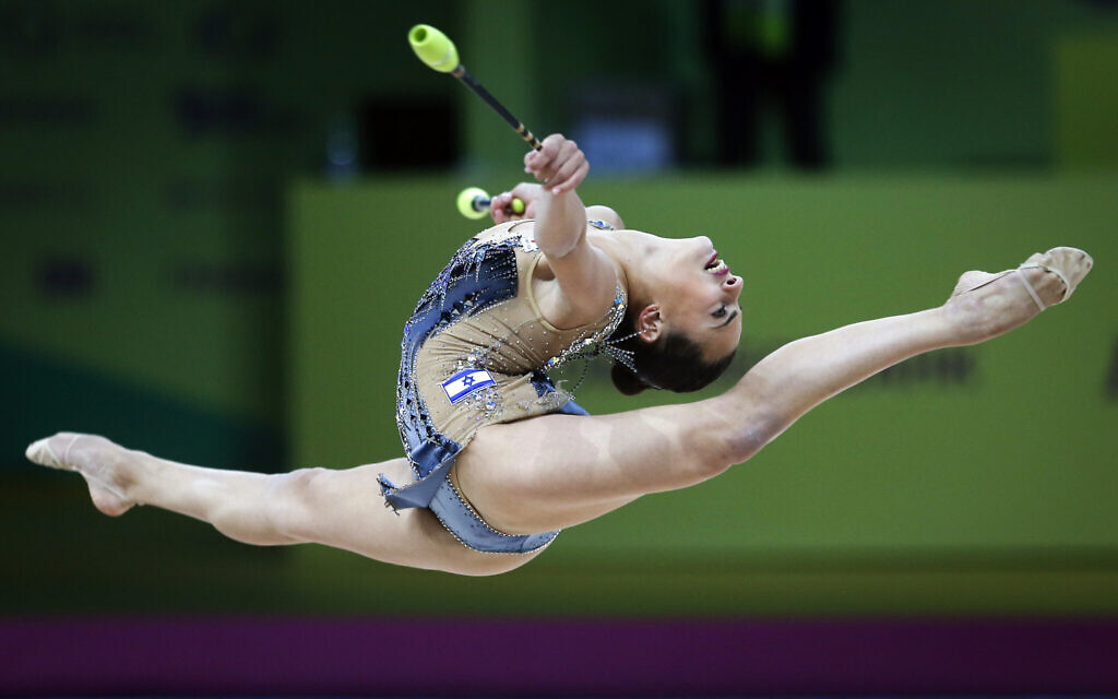 Linoy Ashram of Israel performs with the clubs during the 36th European Rhythmic Gymnastics Championships in Kyiv, Ukraine, on November 29, 2020. (AP Photo/Efrem Lukatsky)