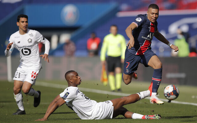 PSG's Kylian Mbappe, right, fights for the ball with Lille's Tiago Djalo during the French League One soccer match between Paris Saint Germain and Lille, at the Parc des Princes stadium, in Paris, France, on April 3, 2021. (AP Photo/Christophe Ena) PSG's Kylian Mbappe, right, fights for the ball with Lille's Tiago Djalo during the French League One soccer match between Paris Saint Germain and Lille, at the Parc des Princes stadium, in Paris, France, on April 3, 2021. (AP Photo/Christophe Ena)