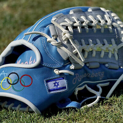 The glove of Israel Olympic baseball player Jake Roseberg sits on the field at Salt River Fields spring training facility, Wednesday, May 12, 2021, in Scottsdale, Arizona. Israel has qualified for the six-team baseball tournament at the Tokyo Olympic games which will be its first appearance at the Olympics in any team sport since 1976. (AP Photo/Matt York) The glove of Israel Olympic baseball player Jake Roseberg sits on the field at Salt River Fields spring training facility, Wednesday, May 12, 2021, in Scottsdale, Arizona. Israel has qualified for the six-team baseball tournament at the Tokyo Olympic games which will be its first appearance at the Olympics in any team sport since 1976. (AP Photo/Matt York)
