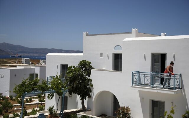 A worker cleans the balcony of a hotel room in Agios Prokopios village, on the Aegean island of Naxos, Greece, May 12, 2021 (AP Photo/Thanassis Stavrakis) A worker cleans the balcony of a hotel room in Agios Prokopios village, on the Aegean island of Naxos, Greece, May 12, 2021 (AP Photo/Thanassis Stavrakis)