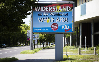 An election campaign poster of the far-right Alternative for Germany, AfD, party stands near a road in the federal state Saxony-Anhalt's capital in Magdeburg, Germany, on June 2, 2021. (AP Photo/Markus Schreiber)
