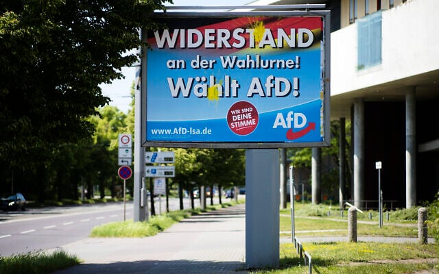 An election campaign poster of the far-right Alternative for Germany, AfD, party stands near a road in the federal state Saxony-Anhalt's capital in Magdeburg, Germany, on June 2, 2021. (AP Photo/Markus Schreiber)