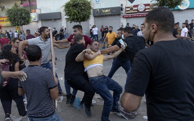 Palestinian security officers in plainclothes detain a demonstrator during clashes that erupted following a rally protesting the death of Palestinian Authority outspoken critic Nizar Banat, in the West Bank city of Ramallah, on June 26, 2021. (AP Photo/Nasser Nasser) Palestinian security officers in plainclothes detain a demonstrator during clashes that erupted following a rally protesting the death of Palestinian Authority outspoken critic Nizar Banat, in the West Bank city of Ramallah, on June 26, 2021. (AP Photo/Nasser Nasser)