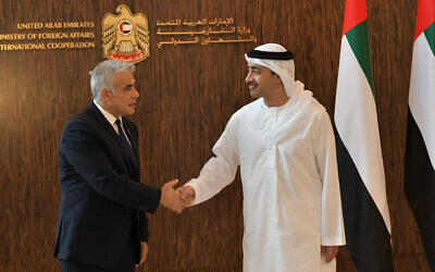 Foreign Minister Yair Lapid shakes hands with United Arab Emirates Foreign Minister Sheikh Abdullah bin Zayed al-Nahyan in Abu Dhabi, United Arab Emirates, Tuesday, June 29, 2021. (Shlomi Amsalem/Government Press Office via AP)
