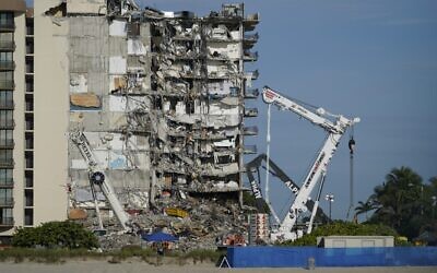 Workers peer up at the rubble pile at the partially collapsed Champlain Towers South condo building, on Thursday, July 1, 2021, in Surfside, Florida (AP Photo/Mark Humphrey) Workers peer up at the rubble pile at the partially collapsed Champlain Towers South condo building, on Thursday, July 1, 2021, in Surfside, Florida (AP Photo/Mark Humphrey)