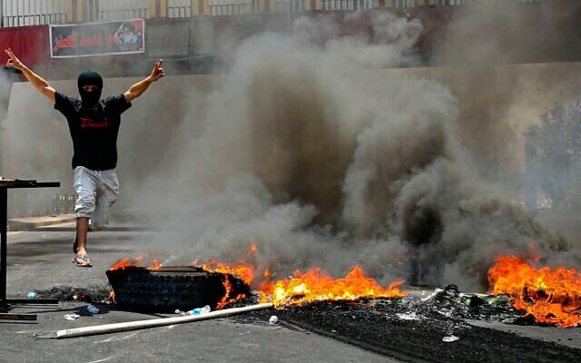 Protesters burn tires to block roads during a demonstration demanding the return of electricity in Basra, southeast of Baghdad, Iraq, July 2, 2021. (AP/Nabil al-Jurani) Protesters burn tires to block roads during a demonstration demanding the return of electricity in Basra, southeast of Baghdad, Iraq, July 2, 2021. (AP/Nabil al-Jurani)
