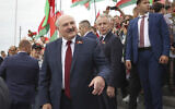Belarusian President Alexander Lukashenko speaks with people after the wreath laying ceremony at Mound of Glory war memorial marking Independence Day, on the outskirts of the capital Minsk, Belarus, July 3, 2021. (Maxim Guchek/BelTA Pool Photo via AP)